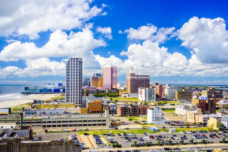 Scenic skyline of Atlantic City, New Jersey with beachfront and high-rise buildings under a bright sky.