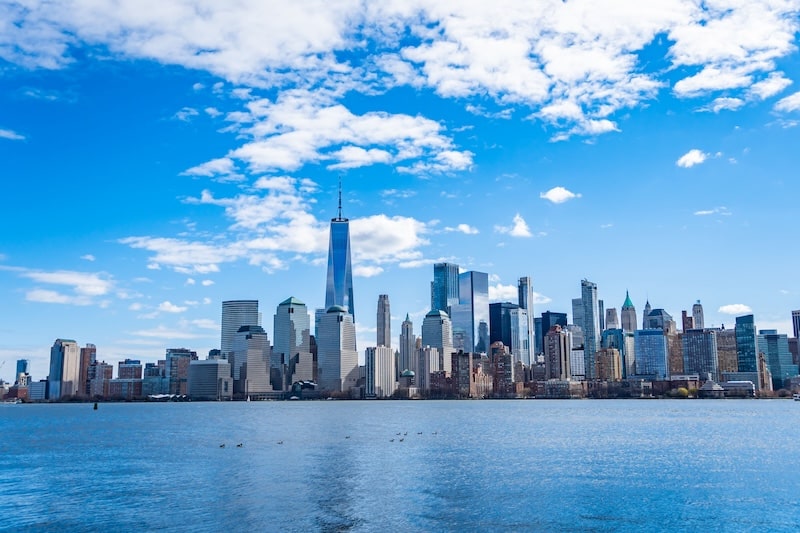 View of the New York City skyline with waterfront and clear blue sky