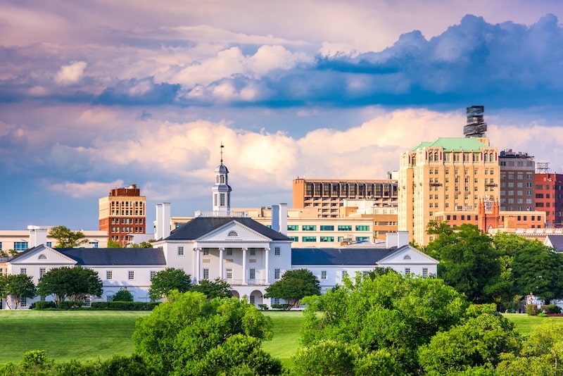 Richmond, Virginia skyline with historic white building and downtown high-rises on a cloudy day.
